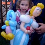 girl holding baloons