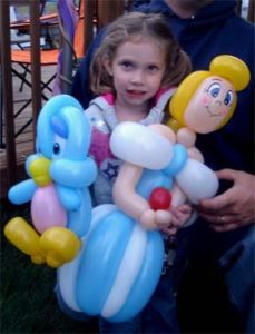 girl holding baloons